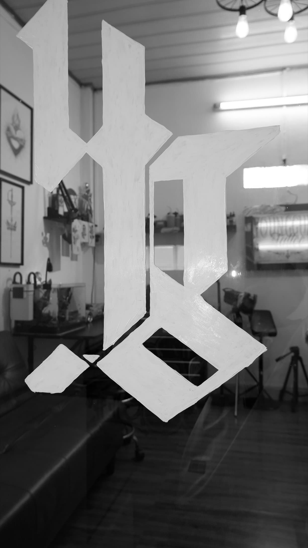 Hand-painted studio mark on the shop window